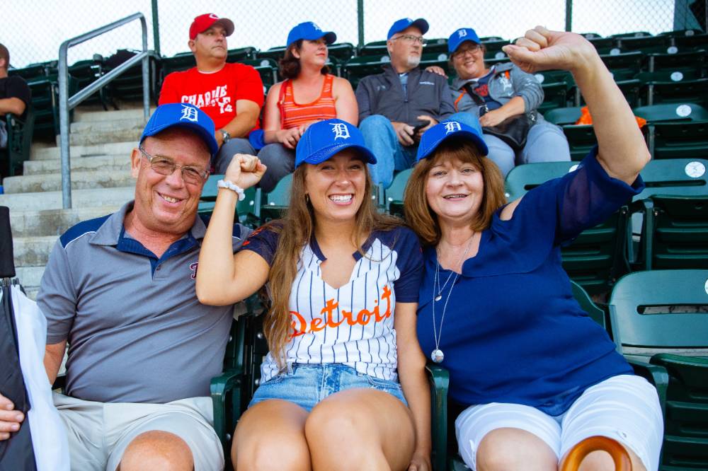 Family of three posing at the Comerica Park event